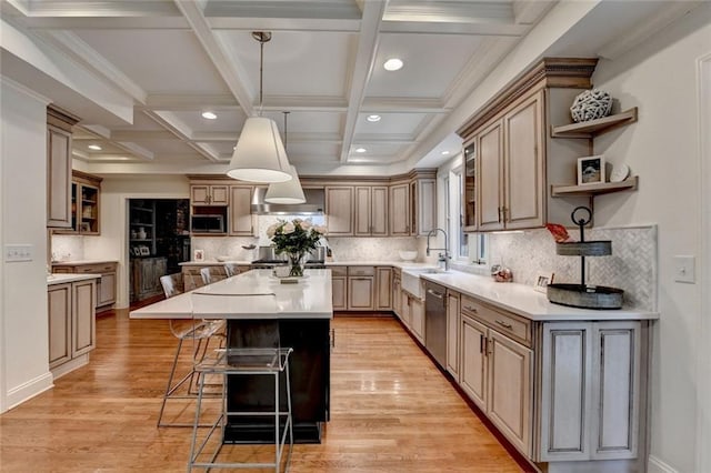 5475 Trowbridge Dr, Dunwoody, GA 30338 - kitchen with open shelves, appliances with stainless steel finishes, a kitchen bar, a sink, and a center island