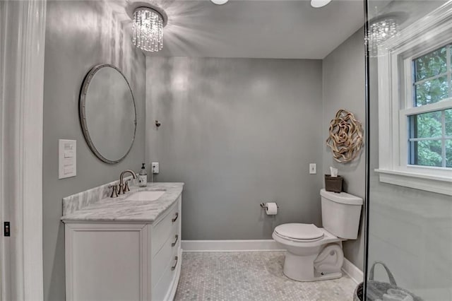 5475 Trowbridge Dr, Dunwoody, GA 30338 - bathroom featuring baseboards, an inviting chandelier, toilet, vanity, and tile patterned flooring