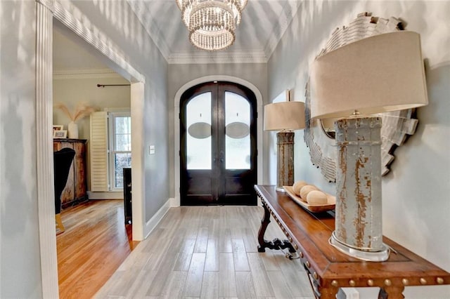 5475 Trowbridge Dr, Dunwoody, GA 30338 - entrance foyer featuring wood finished floors, an inviting chandelier, french doors, and crown molding