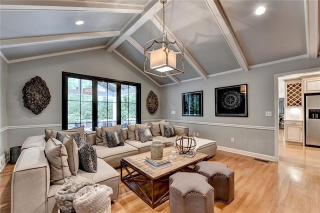 5475 Trowbridge Dr, Dunwoody, GA 30338 - living room with light wood finished floors, a chandelier, vaulted ceiling with beams, a wainscoted wall, and visible vents