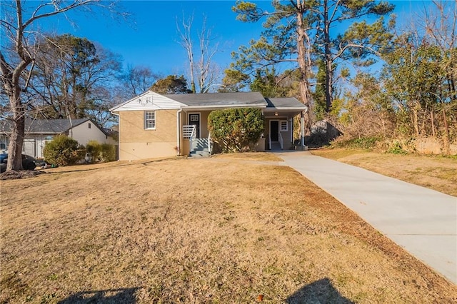 view of front of property with a front lawn and a carport