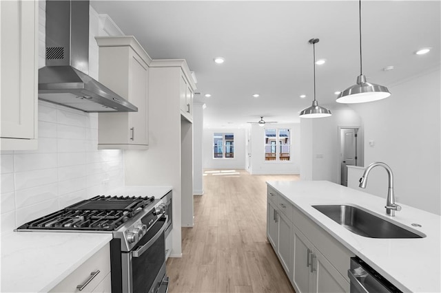 3167 Moor View Rd Unit 35, Duluth, GA 30096 - kitchen featuring wall chimney range hood, appliances with stainless steel finishes, tasteful backsplash, a sink, and light wood-type flooring