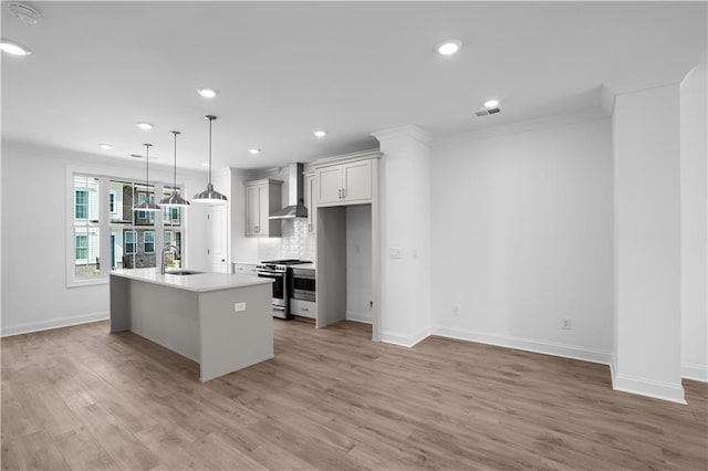 3167 Moor View Rd Unit 35, Duluth, GA 30096 - kitchen with a sink, stainless steel gas range, recessed lighting, wall chimney exhaust hood, and an island with sink