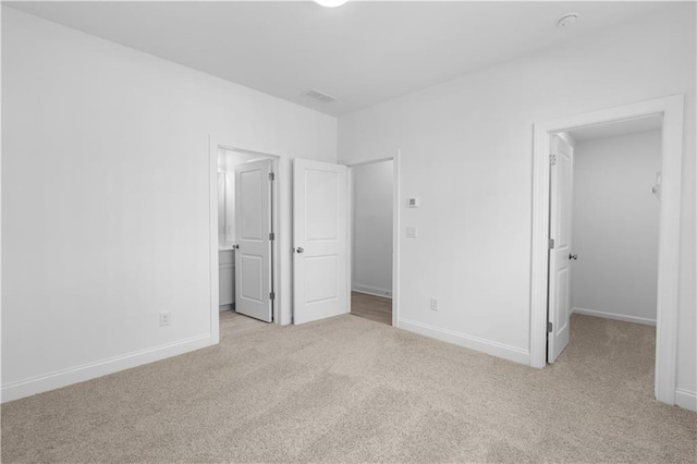 3167 Moor View Rd Unit 35, Duluth, GA 30096 - unfurnished bedroom with baseboards, carpet, a walk in closet, and visible vents