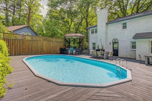 view of pool with outdoor dining area and a deck