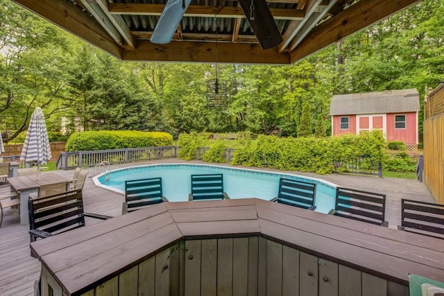 view of pool with fence, a fenced in pool, and a wooden deck
