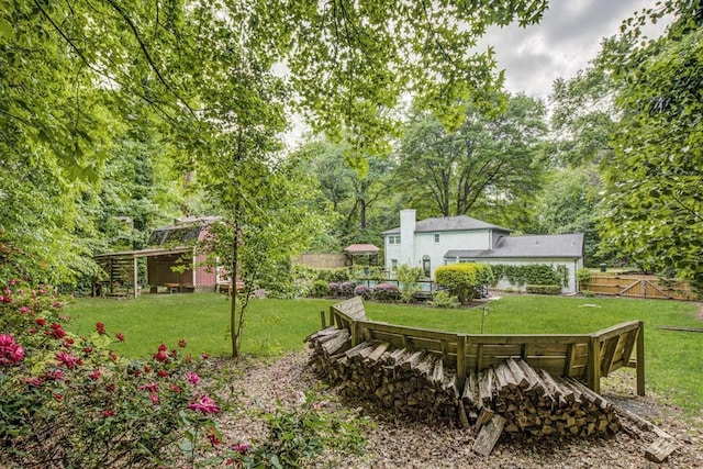 view of yard featuring fence and an outdoor structure