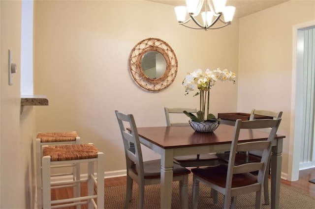 1676 Northridge Dr, Morrow, GA 30260 - dining space featuring baseboards, a notable chandelier, and wood finished floors