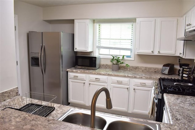 1676 Northridge Dr, Morrow, GA 30260 - kitchen featuring under cabinet range hood, white cabinetry, stainless steel fridge, and a sink