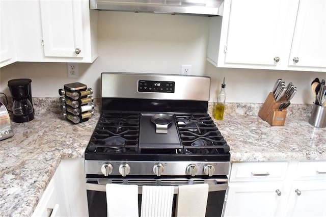1676 Northridge Dr, Morrow, GA 30260 - kitchen with stainless steel range with gas cooktop, white cabinetry, extractor fan, and light stone countertops