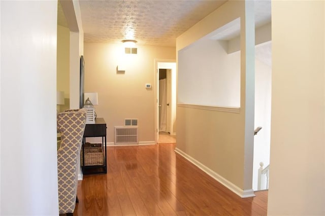 1676 Northridge Dr, Morrow, GA 30260 - corridor featuring baseboards, wood-type flooring, an upstairs landing, and visible vents