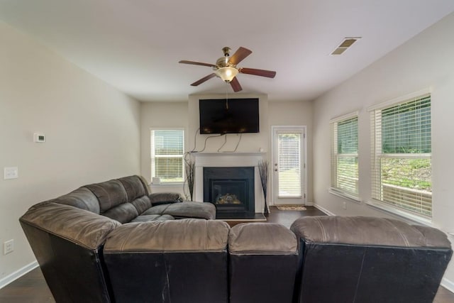 living room with ceiling fan and dark hardwood / wood-style flooring