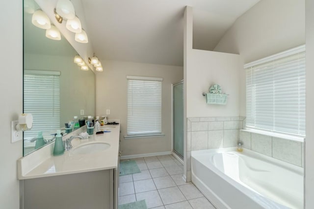 bathroom with tile patterned floors, vanity, vaulted ceiling, and shower with separate bathtub