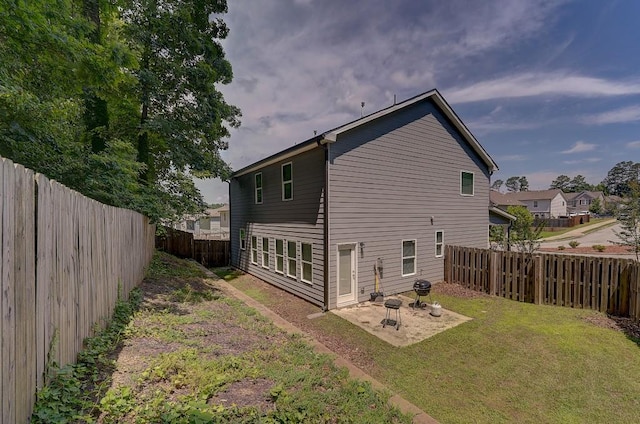 back of house featuring a yard and a patio