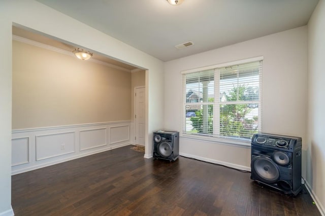unfurnished room with crown molding and dark hardwood / wood-style floors