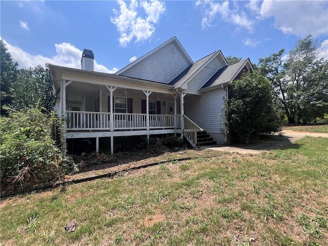 view of front of home featuring a chimney and a porch