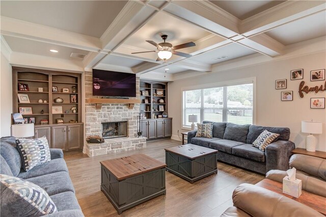 living room featuring light hardwood / wood-style floors, coffered ceiling, ceiling fan, beam ceiling, and a fireplace