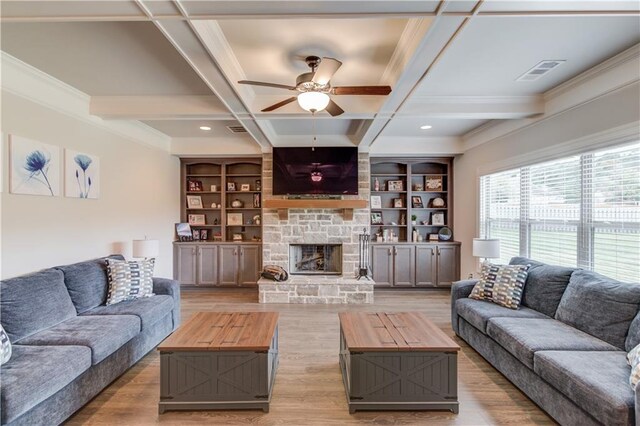 living room with light hardwood / wood-style floors, coffered ceiling, ceiling fan, beam ceiling, and a fireplace