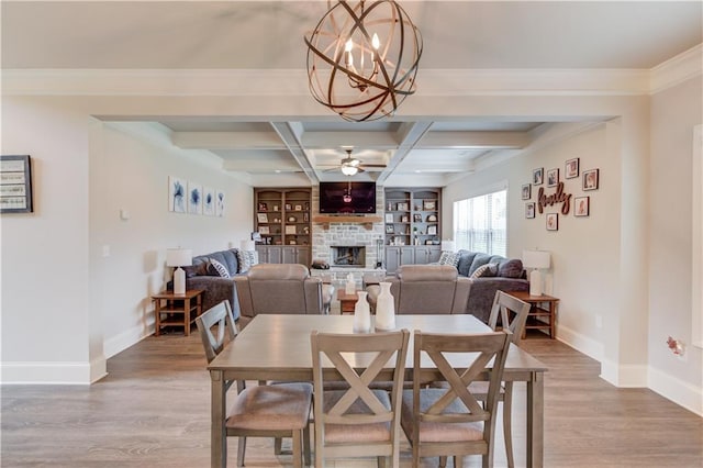 dining room with a fireplace, wood-type flooring, beamed ceiling, and coffered ceiling