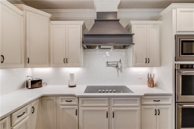 kitchen with tasteful backsplash, custom exhaust hood, black electric cooktop, and crown molding