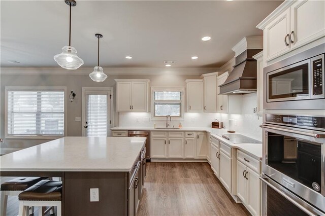 kitchen featuring white cabinetry, hardwood / wood-style floors, appliances with stainless steel finishes, and sink