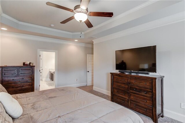 carpeted bedroom with ceiling fan, connected bathroom, and ornamental molding