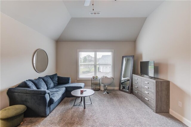 carpeted living room featuring vaulted ceiling and ceiling fan