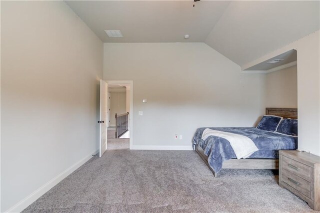 carpeted bedroom featuring lofted ceiling