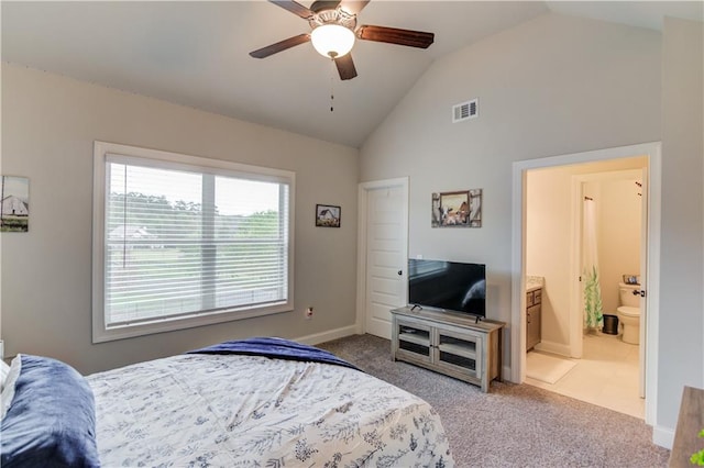 bedroom with ensuite bathroom, ceiling fan, vaulted ceiling, and carpet floors