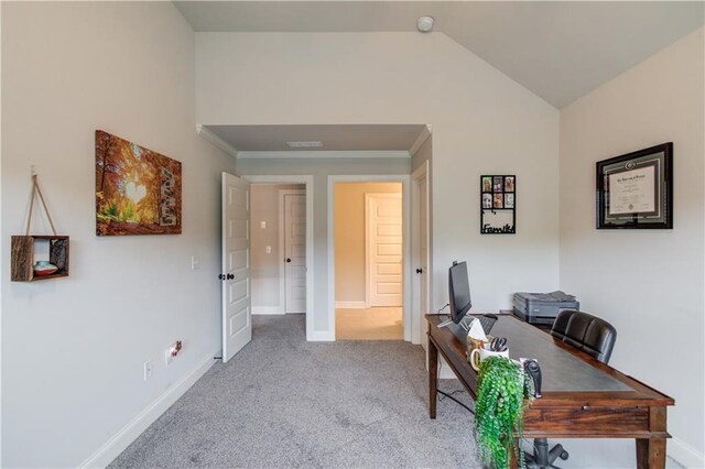 carpeted home office with vaulted ceiling and crown molding