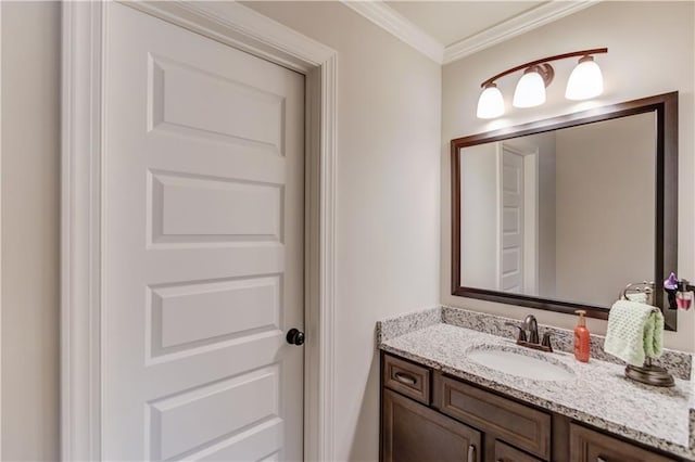 bathroom with ornamental molding and vanity