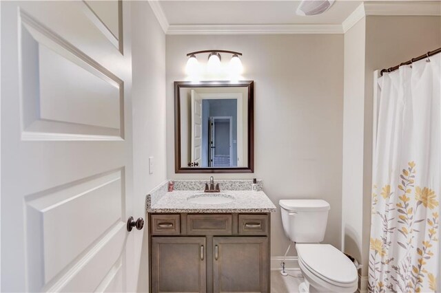 bathroom featuring toilet, vanity, and crown molding