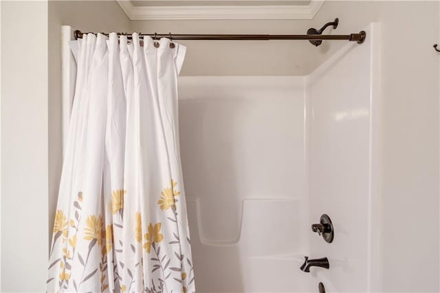 bathroom featuring shower / bath combo and crown molding