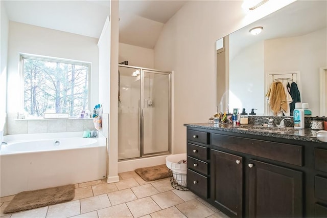 bathroom featuring a stall shower, vanity, a bath, and tile patterned floors