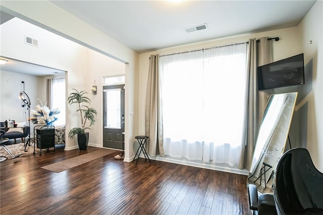 foyer featuring wood finished floors and baseboards