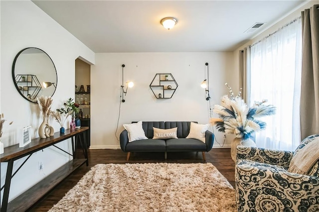living area featuring dark wood-type flooring and baseboards