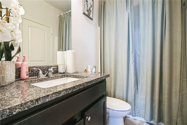 bathroom with toilet and vanity