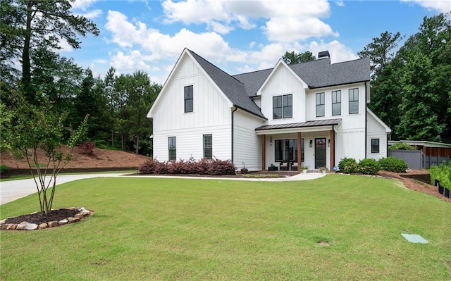 modern inspired farmhouse featuring a porch and a front yard