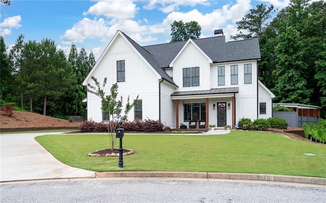 modern farmhouse with a porch and a front yard