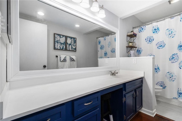 full bathroom featuring toilet, vanity, and wood finished floors