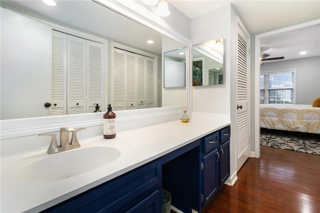 bathroom featuring vanity, hardwood / wood-style flooring, a closet, and ensuite bathroom