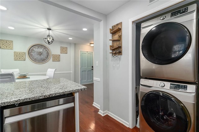 laundry room featuring baseboards, beverage cooler, dark wood finished floors, laundry area, and stacked washing maching and dryer