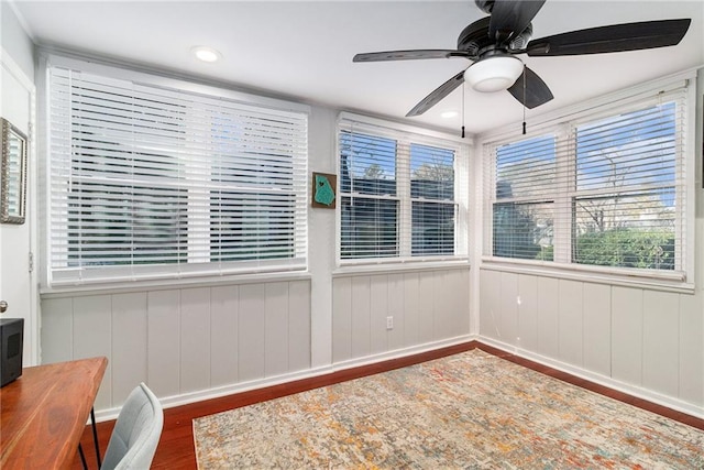 sunroom / solarium with a ceiling fan