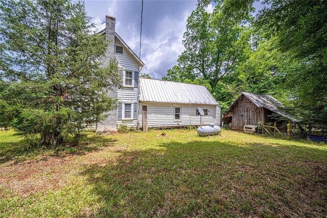 rear view of property with a yard