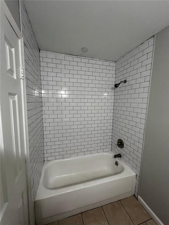 bathroom with tile patterned flooring and tiled shower / bath