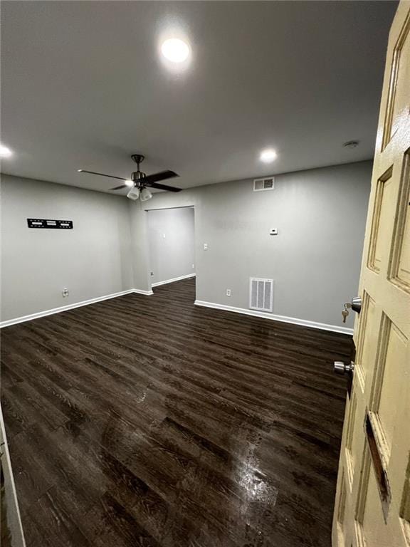 empty room featuring dark hardwood / wood-style floors and ceiling fan