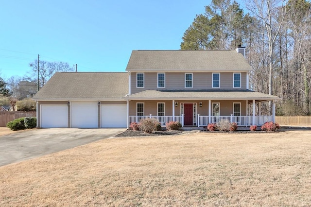 view of front of property with covered porch, a front lawn, and a garage