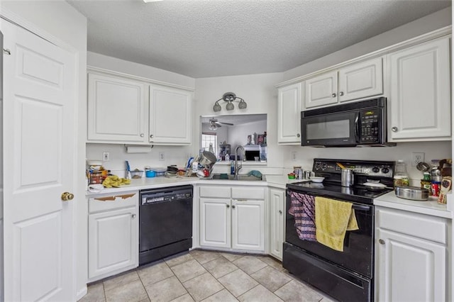 kitchen with black appliances, white cabinets, light countertops, and a sink