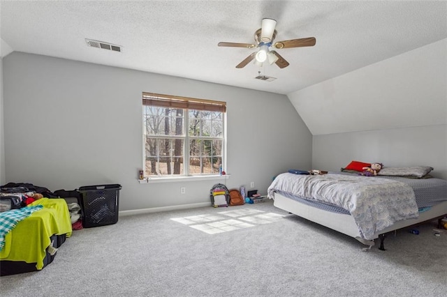 bedroom with visible vents, carpet floors, a textured ceiling, and vaulted ceiling