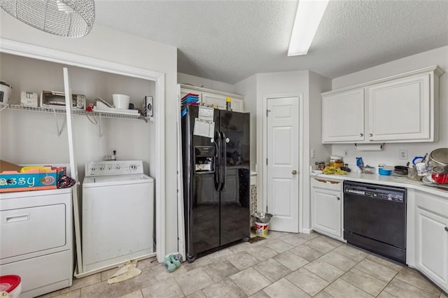 clothes washing area featuring washing machine and clothes dryer, laundry area, and a textured ceiling